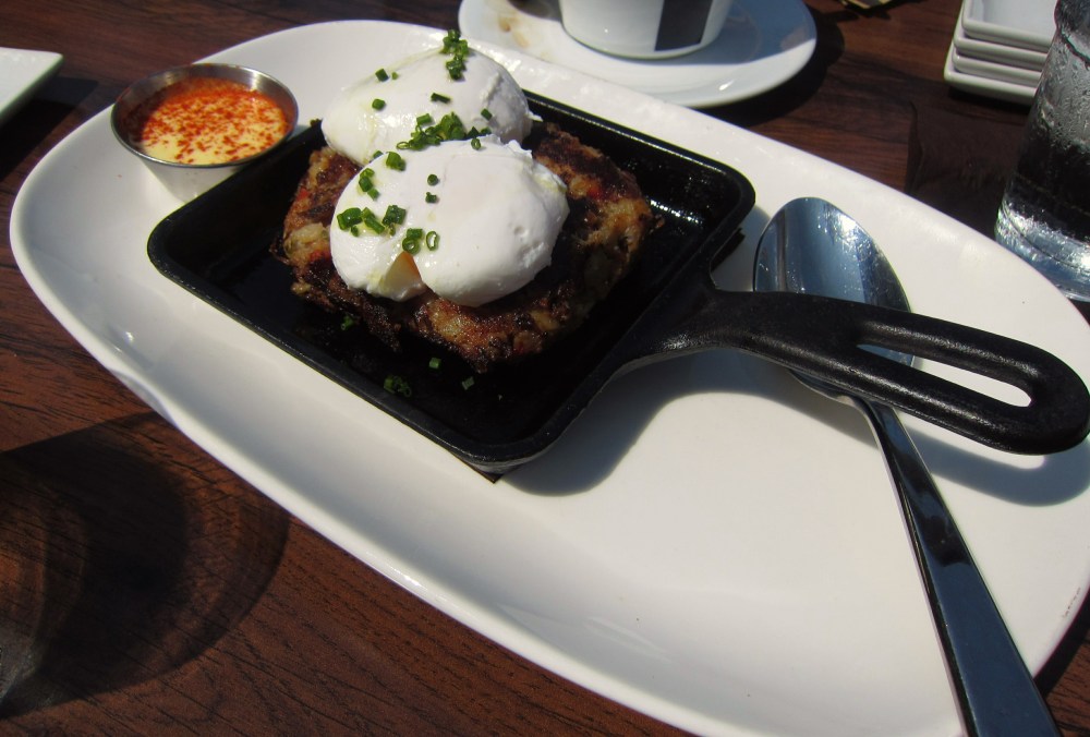 Short rib hash with poached egg and hollandaise topped with smoked paprika