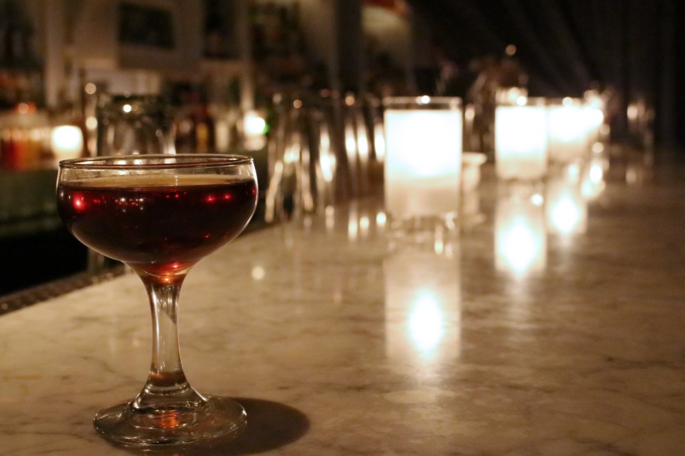 A delicious stirred rum cocktail lit by candles